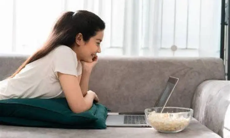 Seseorang menonton film dengan home theater sederhana